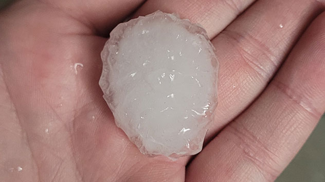 Pflaumengroßes Hagelkorn auf der Hand