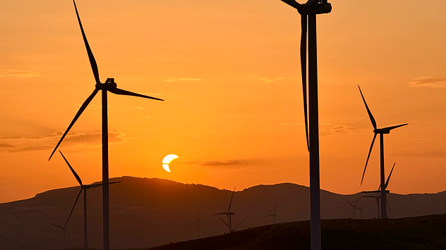Solar eclipse: The sun obscured between wind turbines in Sardinia