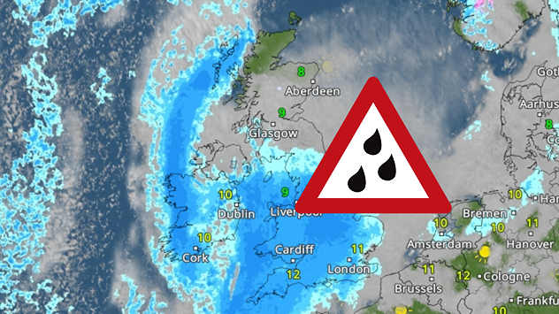 Radar map showing widespread blue rain bands over the UK and Ireland with a triangular heavy-rain warning icon placed over central Britain.