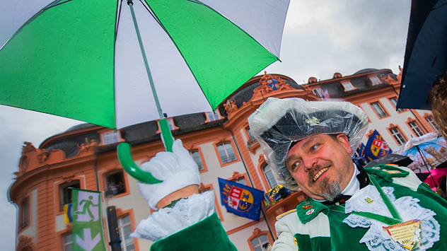 Gardist hält zum Karnevalsauftakt eine Regenschirm.