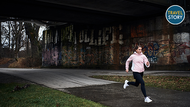 Junge Frau joggt bei Regenwetter.