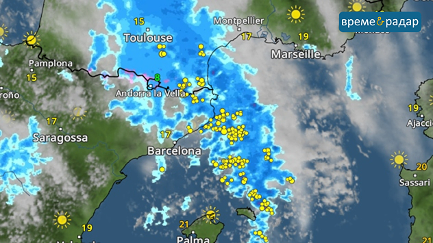 Метео карта с дъждовни зони и предупредителен символ над Южна Франция и Северна Испания.