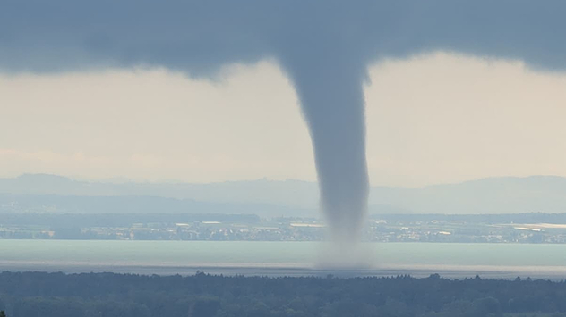 A photograph of a waterspout over Lake Constance