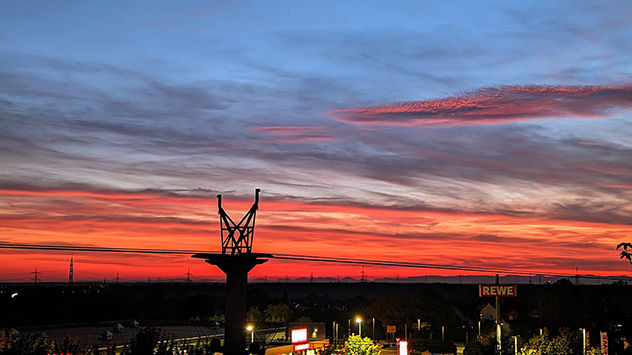 Der glühende Himmel bietet einen grandiosen Kontrast zur dunkler werdenden Landschaft.