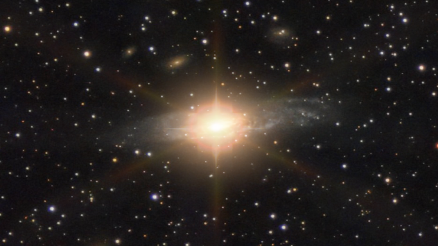 Záběr na galaxii se zářícím světlem ze supernovy.