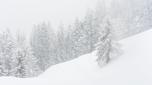 A wintry mountain landscape with heavy snowfall