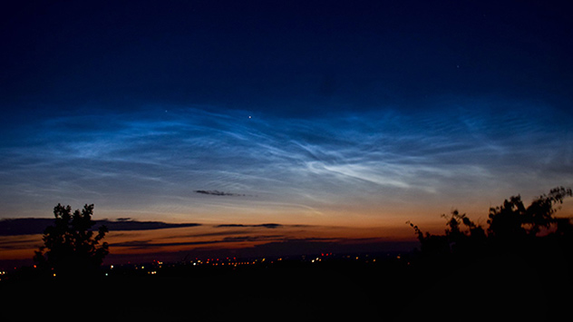 Wellenförmige Silberfäden ziehen sich entlang des Nordhimmels über Südschweden. 