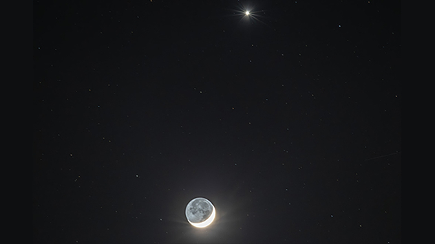 Das blasse Schimmern auf dem dunklen Teil des Mondes wird durch reflektiertes Licht von der dort am Himmel stehenden hellen &quot;Vollerde&quot; verursacht.