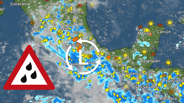 A small weather map showing satellite imagery and precipitation over Europe. A red warning triangle with an exclamation mark is displayed in the bottom left-hand corner. The map shows numerous blue, yellow and orange weather symbols indicating active precipitation or areas of thunderstorms. The graphic conveys a general weather or severe weather warning.