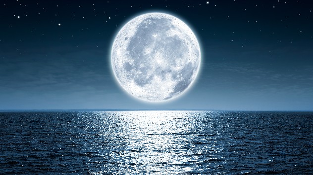 Moon rises over ocean