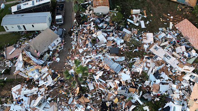 Aerial photograph shows destroyed houses and debris after a tornado.