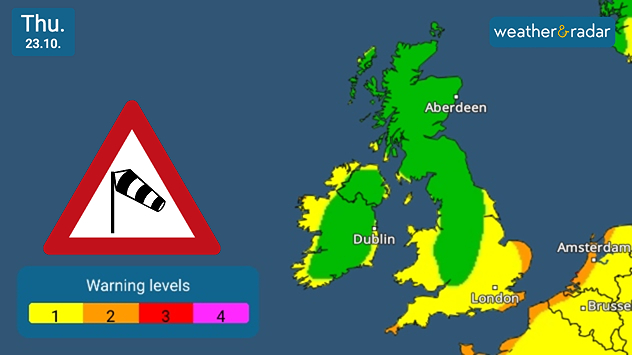 Weather map of the UK and Ireland dated Thursday 23 October showing green to yellow warning levels, with a wind warning sign and colour scale from level 1 to 4. Yellow warning seen along the coasts of Ireland, Wales, and parts of southern to eastern England, orange warnings along the east and south-east coastline of England and in the far south-west.