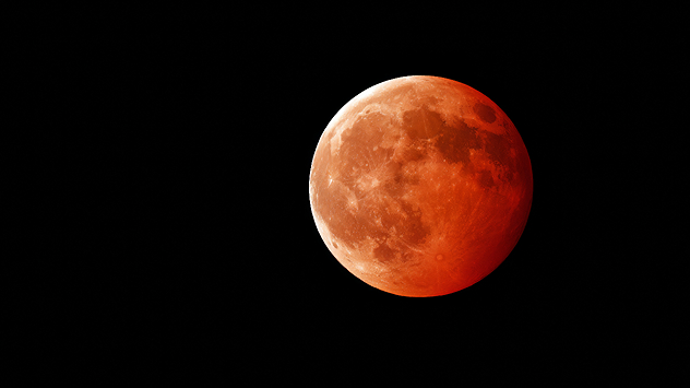 Red moon during a total lunar eclipse in the night sky.