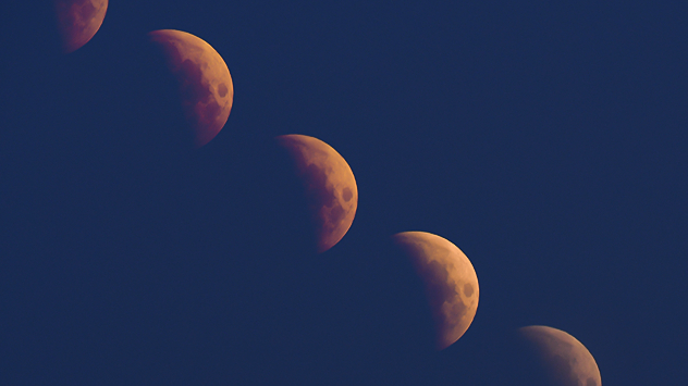 Stages of a partial lunar eclipse taken via time-lapse and stitched together.