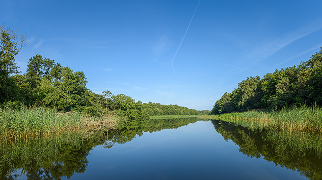 River view with calm waters under mostly clear skies.