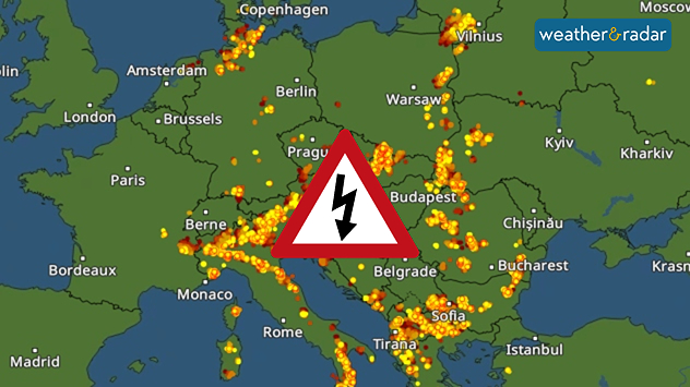 Lightning map of Europe showing widespread thunderstorm activity across central and southeastern Europe, with dense lightning strike clusters around the Alps, northern Italy, the Balkans, and central Europe, plus a thunderstorm warning symbol.
