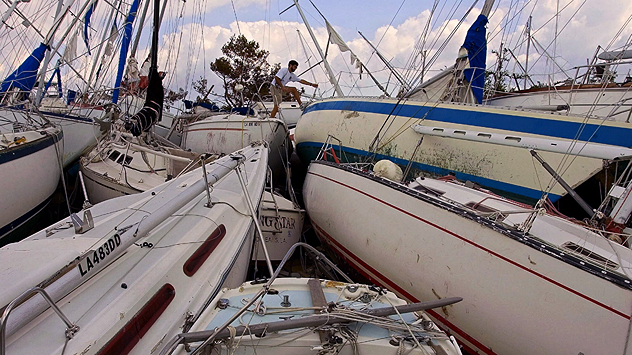 Several sailing boats lie tightly wedged together and damaged in the harbour after Hurricane Katrina.